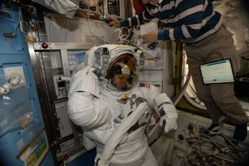 NASA astronaut Zena Cardman in her pressurized spacesuit, checking its comms and power systems ahead of the (now postponed) spacewalk