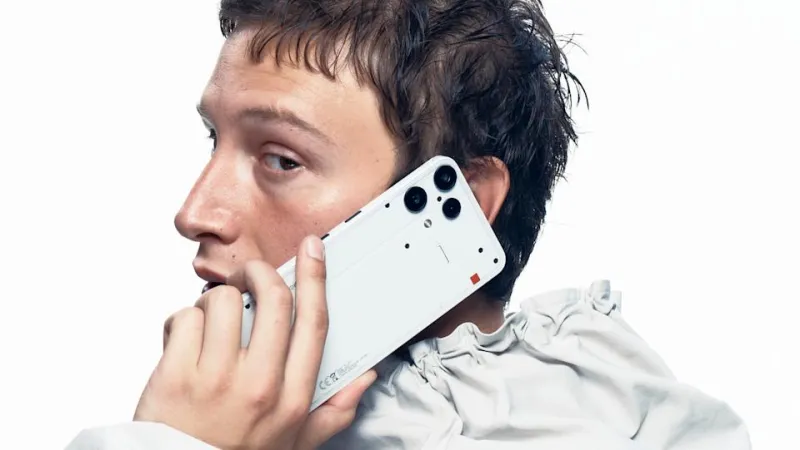 Marketing phone for the Nothing Phone 3a Lite. A suave-looking person holds the phone while on a call, looking nonchalantly over their shoulder toward the camera.