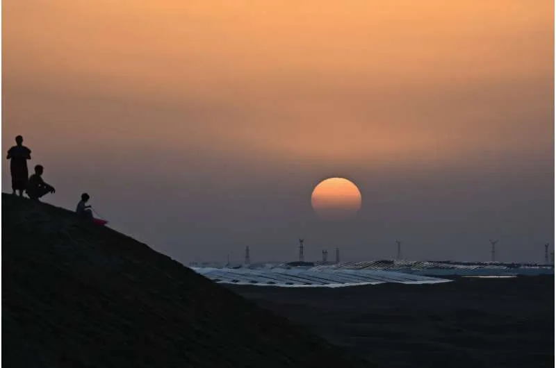 The sun sets over solar panels at the Dalat Banner Photovoltaic Station. Views of the shimmering solar cells have gone viral online, as Kubuqi has become a popular domestic holiday destination
